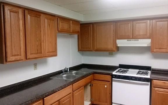 The large kitchen has a gas range, double basin sink, lots of counter space and plenty of storage cabinets.