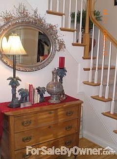 2 story foyer, with hardwood floor and 2 coat closets