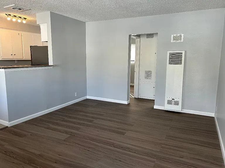 Living room with wall heater, brand new linemate floor with new paint