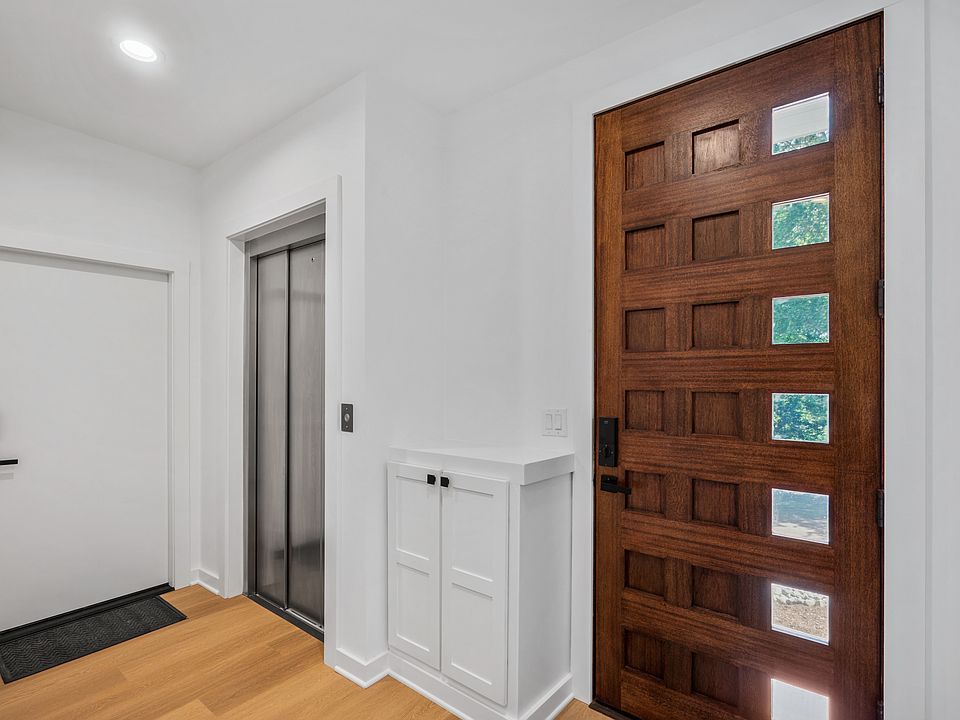Foyer with elevator access and stairwell.