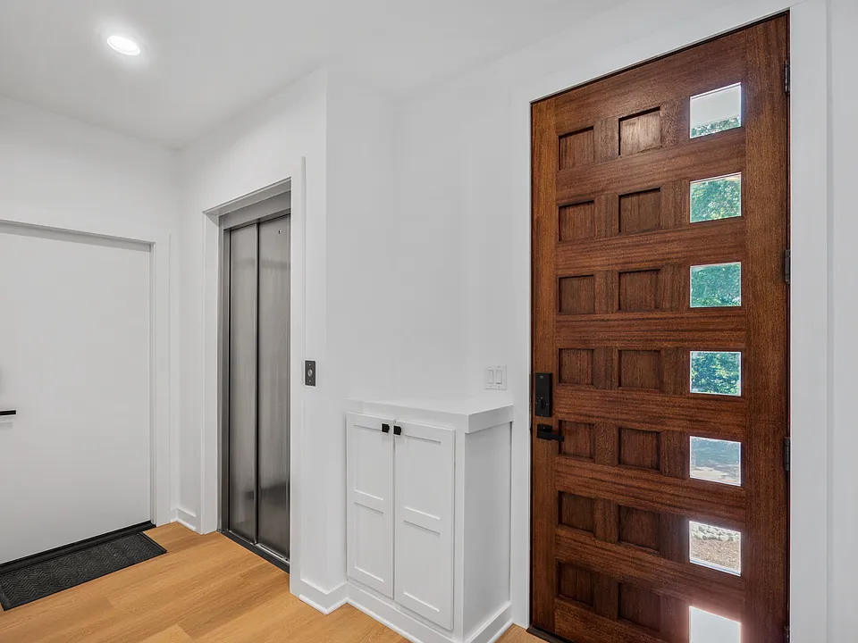 Foyer with elevator access and stairwell.