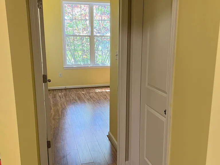 Doors to bedroom (open) and bathroom (closed).