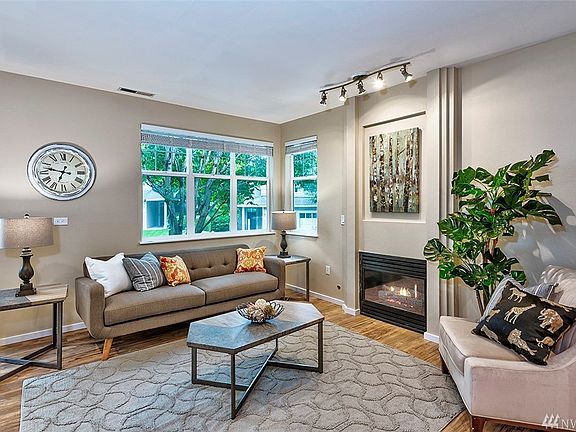 Your first view of this beautiful end unit is this half of the great room which features a cozy gas fireplace. 