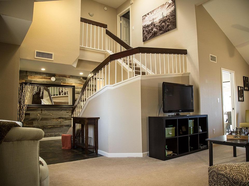 Family room, with front door entrance to left and kitchen to the right. Vaulted ceilings with skylight.