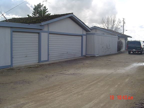 West side shows large shop door.