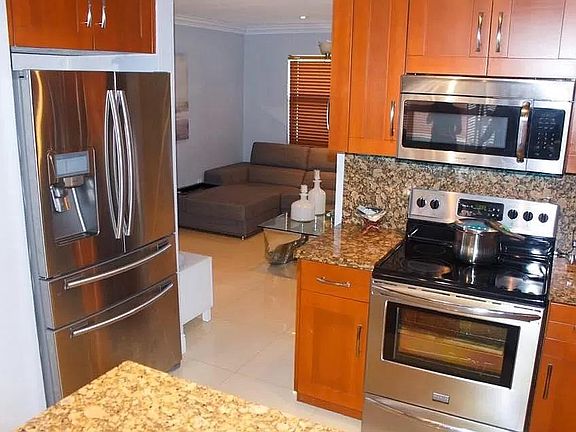 Kitchen is equipped with stainless steel appliances and conveniently located between the living room and dining room; perfect for entertaining. The Samsung double door refrigerator has a dedicated beverage/snack drawer and deep bottom freezer. The smar