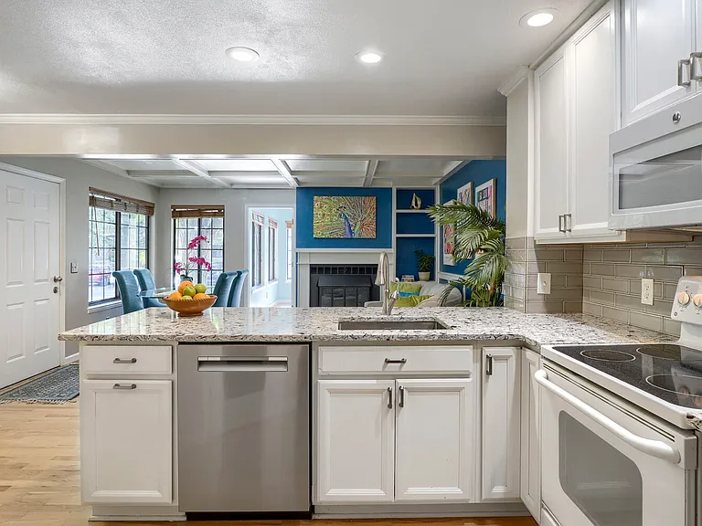 Kitchen to Living Room _ A thoughtfully designed open-concept layout with kitchen counter seating overlooking the living space, creating an inviting flow for cooking, conversation, and entertaining.