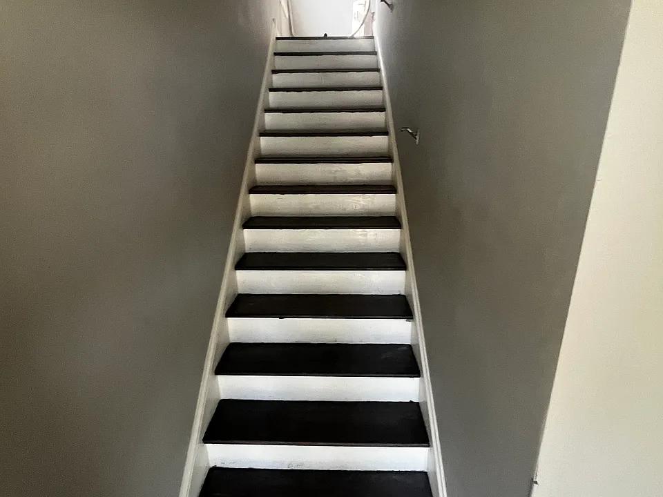 Main stairs, wood threads match hardwood floors.