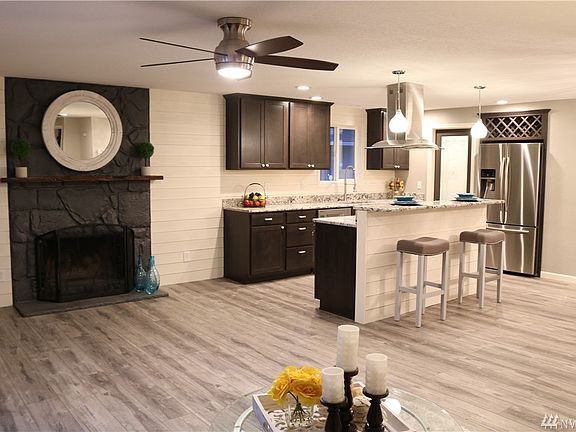 Beautiful stone fireplace w/ custom mantel surrounded by ship-lap accent wall! Wow!!