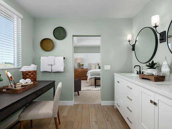 Primary bath with dual sinks and black framed mirrors