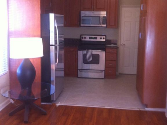 Open floor plan with tile flooring in the kitchen and lamina