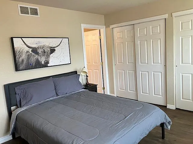 Furnished bedroom with a queen bed setup and generous closet storage, plus convenient access to the master bathroom.