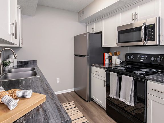 This stylish kitchen features modern stainless steel appliances, sleek countertops, and ample storage space, making it perfect for culinary enthusiasts.