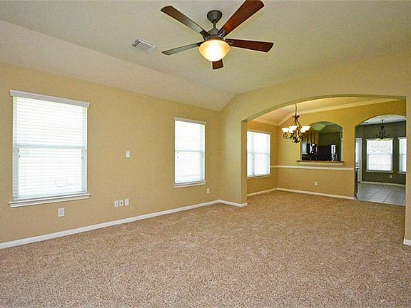 NOTICE CEILING FAN AND NICE ARCHES IN LIVING ROOM