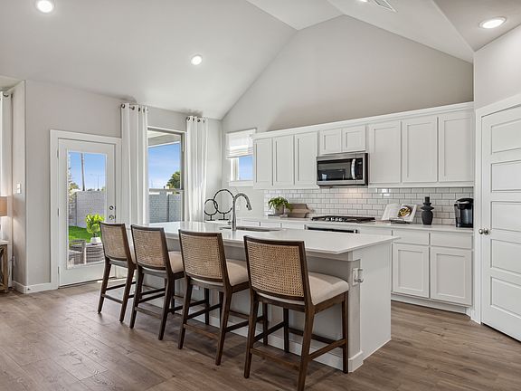 Kitchen in the Wimbledon home plan by Trophy Signature Homes - REPRESENTATIVE PHOTO