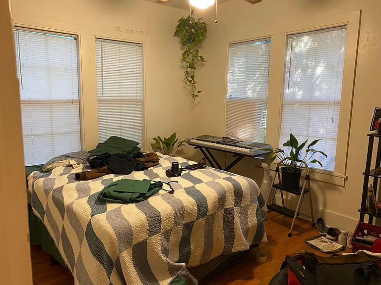 Front Bedroom - original wood floors, 9 ft. ceiling, large closet, ceiling fan, 4 large windows with blinds.