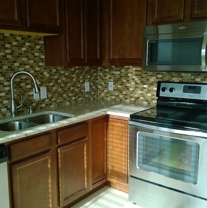 Gorgeous kitchen with travertine tile floor, glass tiles on