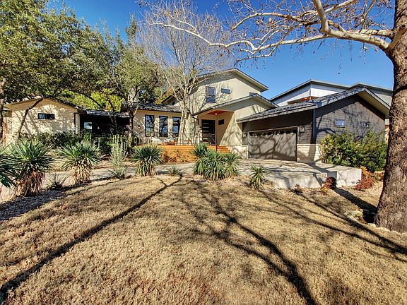 Front view from the road. Picture taken in winter. In summer, the lawn is green, and the trees provide a lot of shade.