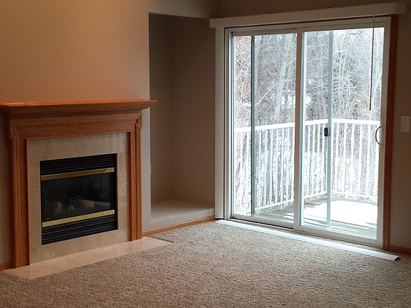 Small deck overlooks a wooded pond