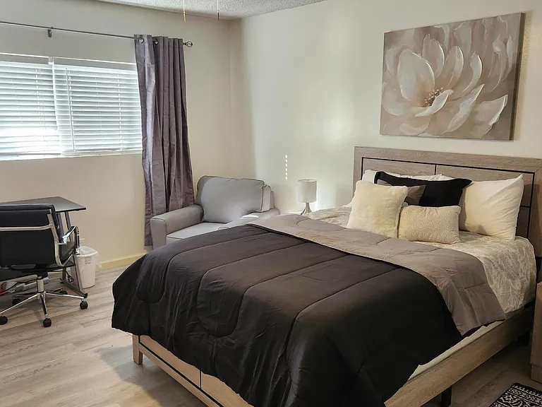 East facing bedroom with large window, blinds and blackout curtains