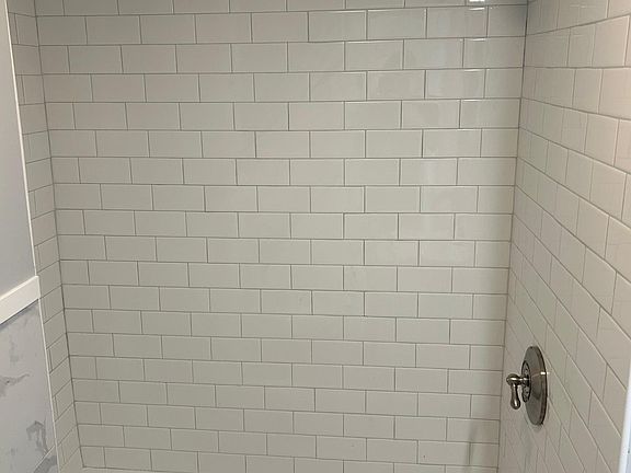 Subway tiled shower with tub
