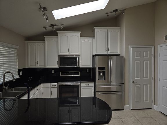 Upgraded kitchen with plenty of natural light and access to back patio