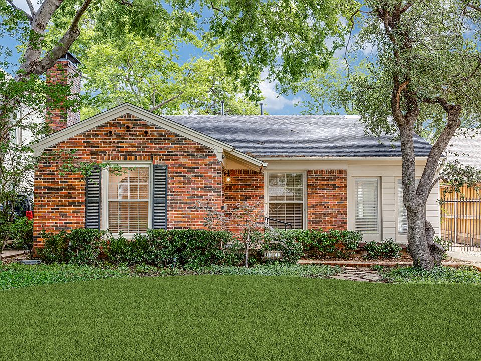 Front of house with beautiful trees and lush grassed lawn