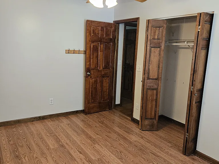 Bedroom #2 w/ hooks and closet shelves