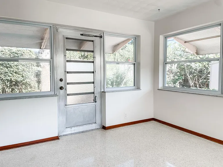 Door to backyard from sunroom on back of house.