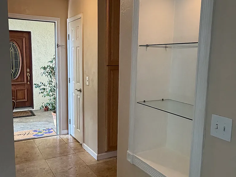 Custom display cabinets and designer wood front door with glass.