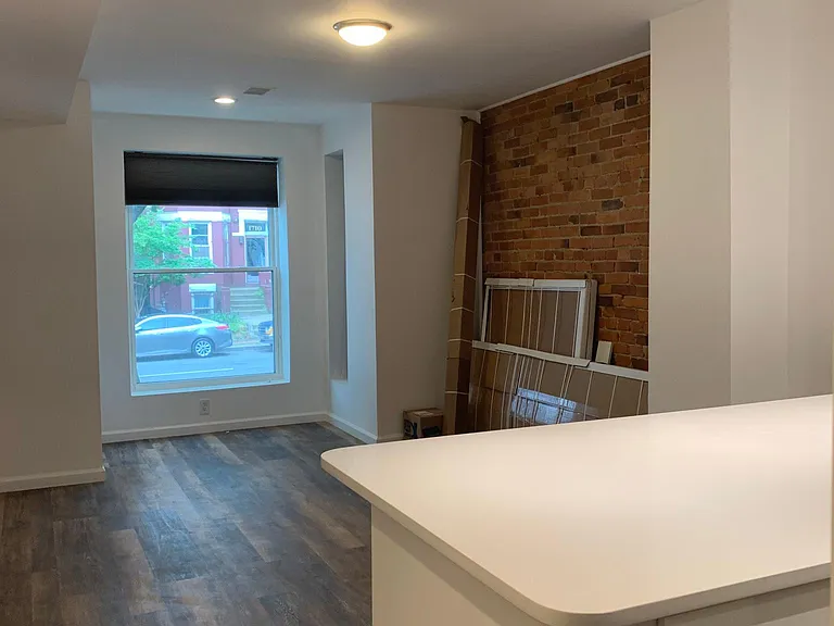 Front View of living area. The window is about 4 ft above the sidewalk area.