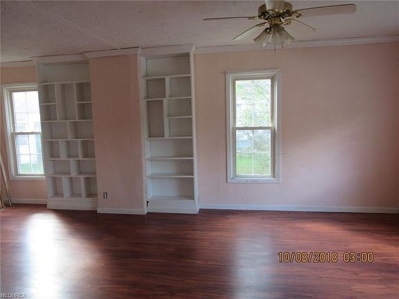 Large living room with new laminate floor, built ins and good natural light.