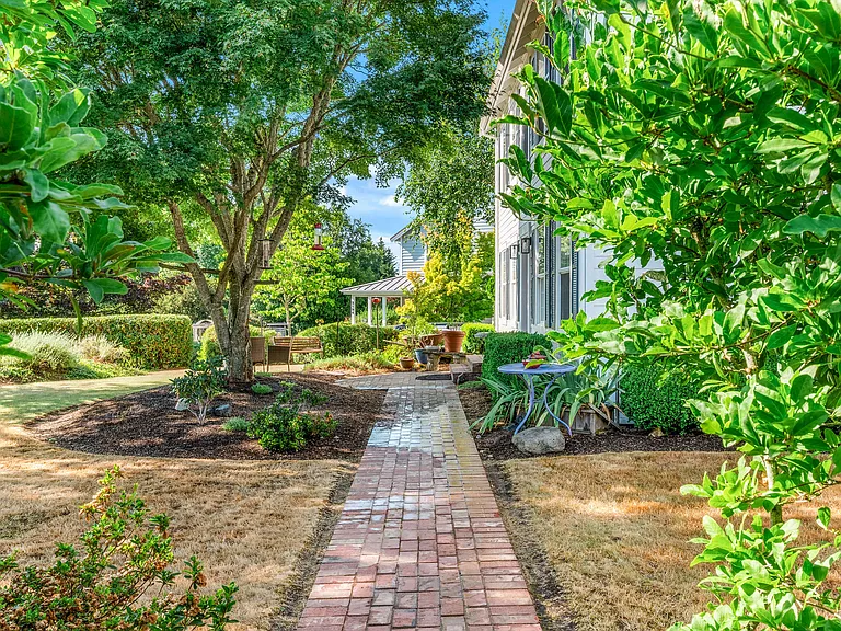 The charming brick walkway invites you to the front entry.