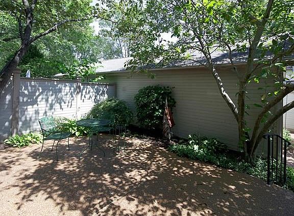River rock enchanted patio area, privacy fence and 2 car garage in back.