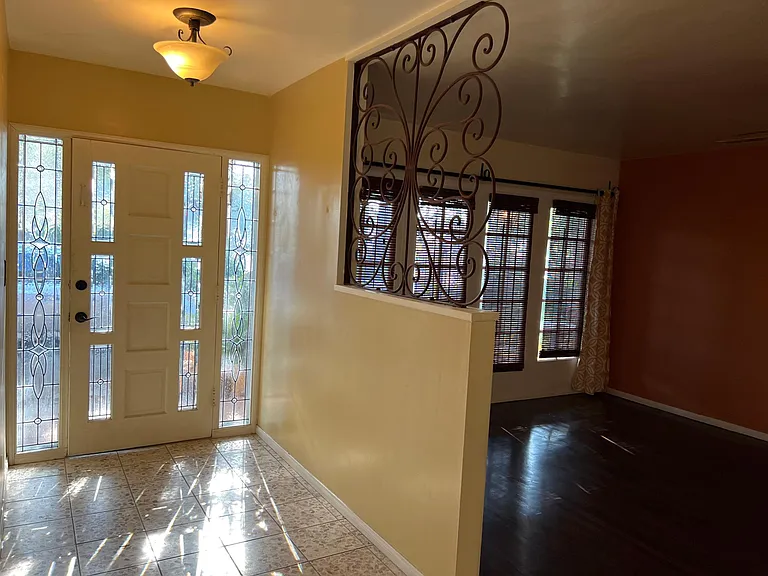 Custom leaded glass door and side lites. Terrazzo Italian tile. Original hardwood floors. Custom Wrought Iron work.