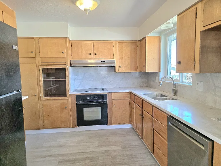 Kitchen with granite countertops, new dishwasher, new porcelain floors, new sink, faucet