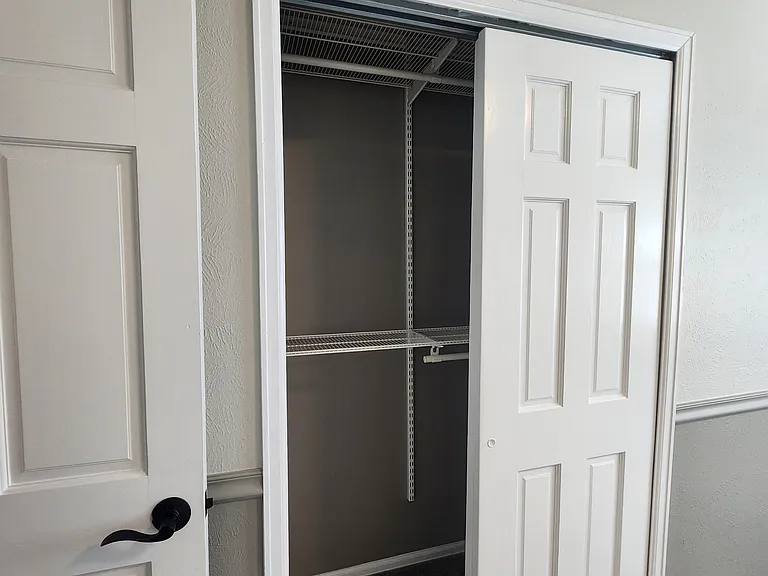 Bedroom #2 with Elfa closet system.