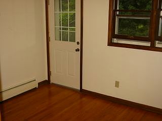Back bedroom features hardwood floors and a balcony overlook