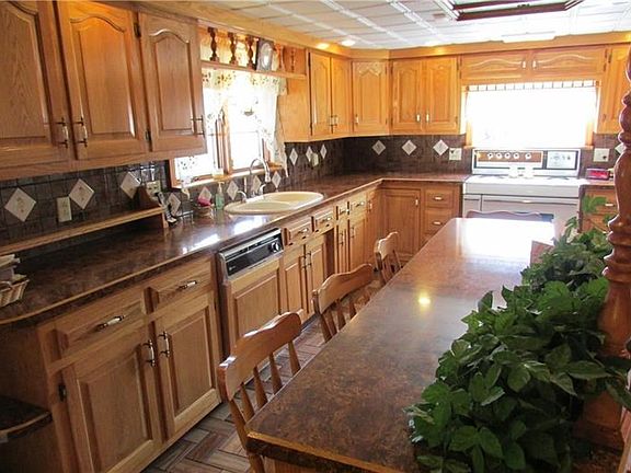 Custom made oak cabinets with ceramic backsplash and ceramic floors.
