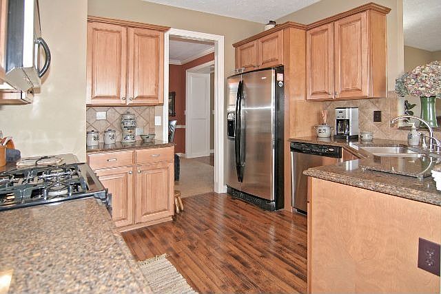Kitchen offers granite countertops and stainless steel appliances.