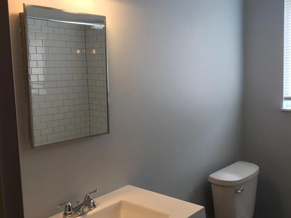 New bath with vanity and tiled shower