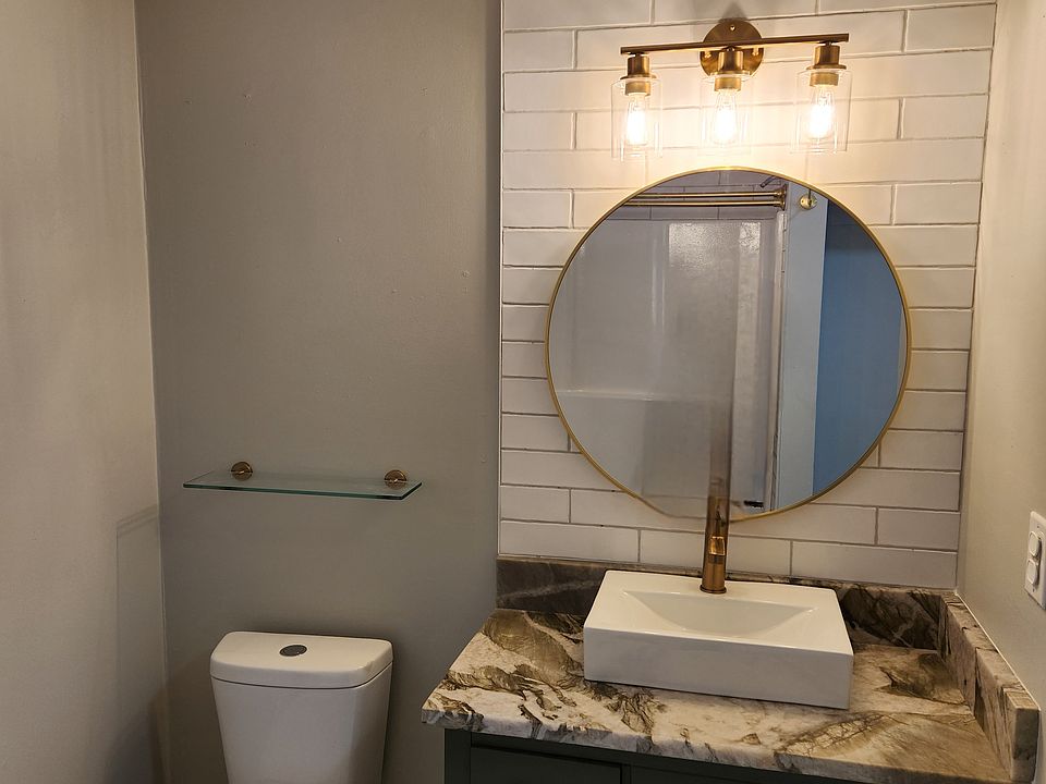 HIGH END QUARTZITE VANITY COUNTERTOP, FLOOR TO CEILING SUBWAY TILE WITH WHITE MOSAIC FLOORING IN BATHROOM. WASHER AND DRYER HOOKUPS.