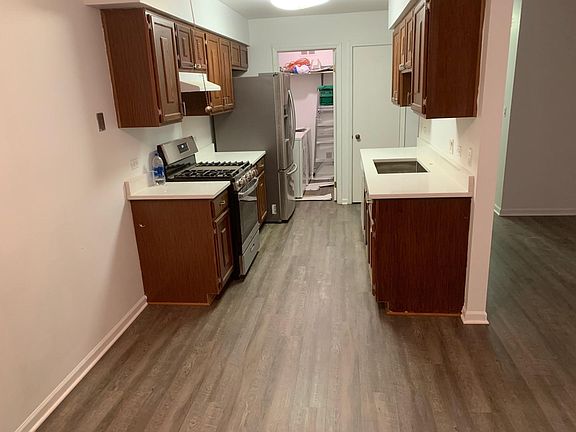 Kitchen with new counters, new gas stove, new sink and recent large refrigerator.