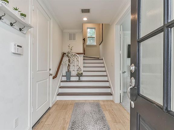 Spacious foyer complete with wood floors. The 2-car garage is located to the left, first floor bedroom is located to the right.