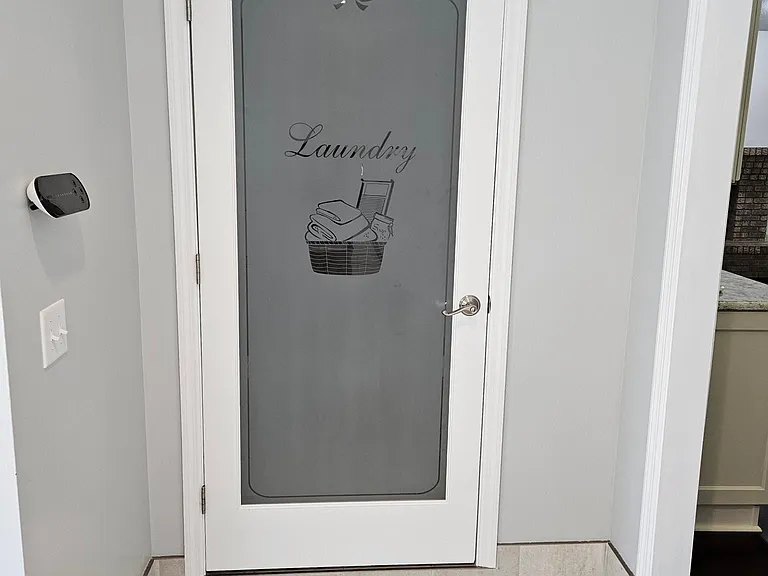 Entrance to laundry room. Wifi enabled sprinkler head unit on the wall to the left.
