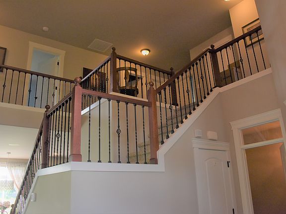 Cathedral Ceiling and Wrought Iron Bannister