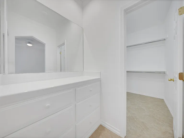 Dressing area looking into walk in closet