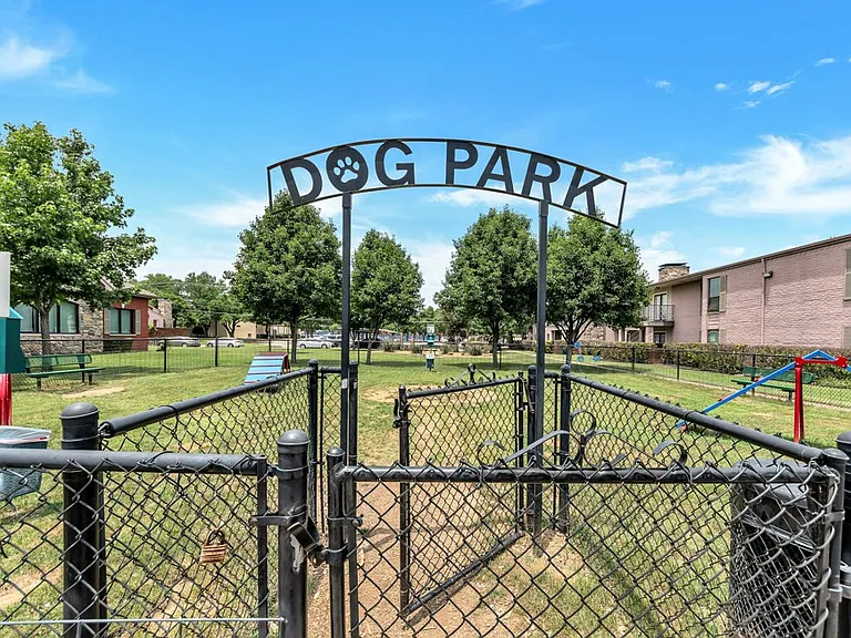 Dedicated fenced dog park offering plenty of space for pets to run, play, and socialize.