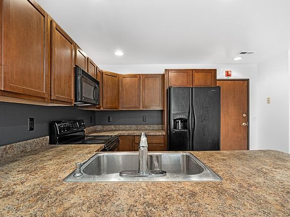Kitchen has fridge, oven, dishwasher, microwave
