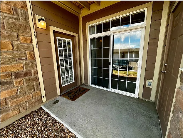 Porch area off dining room and first bedroom with outside storage area (right).